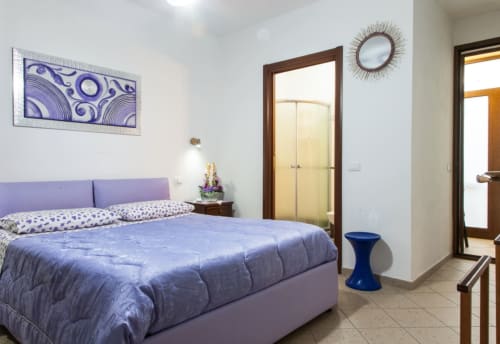 Camera Doppia Lilla presso Affittacamere Al Mare, Torre Grande Oristano con biancheria viola, servizi moderni e vista sul giardino