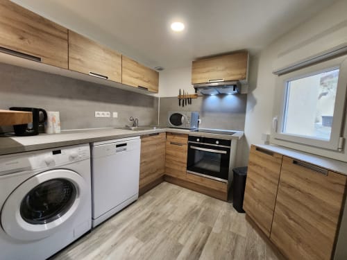 Modern kitchen in cottage at Domaine à l'Aise, Saint-Pargoire with wooden cabinets and appliances