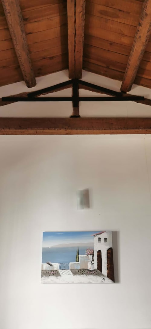 Wooden beamed ceiling in Casa Bellini apartment with Palermo coastal artwork on white wall