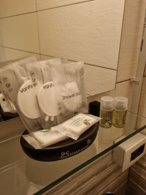 Bathroom amenities display at B&B Il Conservatorio Naples including shower cap, soap dish, toiletries and complimentary