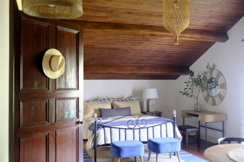 Cozy bedroom at Villa Várzea in Várzea with wrought iron bed, wooden ceiling, and blue accents
