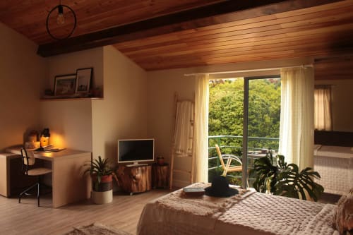 Warm bedroom at Villa Várzea B&B in Várzea, Portugal, with wooden ceiling, desk, TV, and balcony overlooking greenery