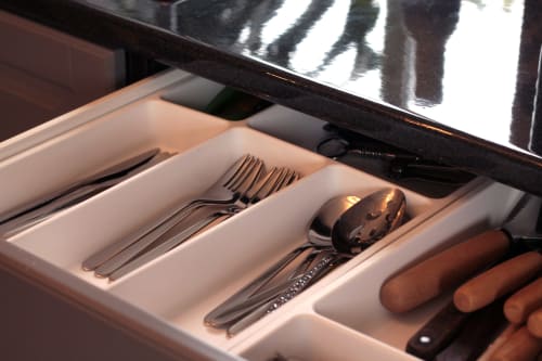 Open drawer with organized silverware and kitchen utensils at Villa Várzea, a boutique B&B in Várzea, Portugal.
