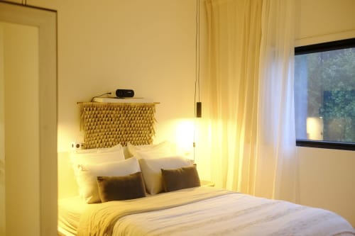 Cozy bedroom at Villa Várzea with warm lighting, textured headboard, and modern amenities in Várzea, Portugal