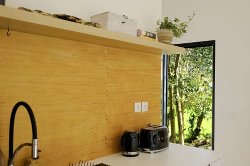 Villa Várzea kitchenette with wooden accent wall, modern appliances, and garden view in Várzea, Portugal