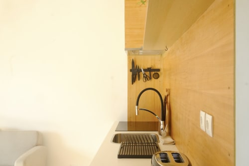 Kitchen area at Villa Várzea with wooden cabinets, sink with faucet, and utensil storage in Várzea