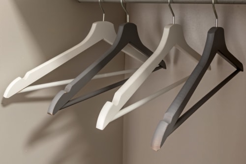 Four empty wooden coat hangers on a rod at Casa Mirko boutique hotel in Arezzo, Italy Room 2