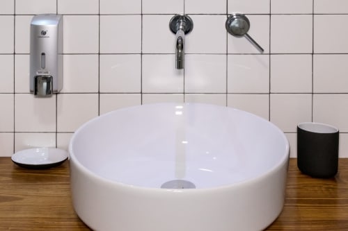 Modern white round vessel sink with faucet at Casa Mirko B&B in Arezzo, Italy - Room 2 bathroom amenities