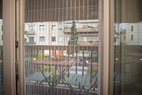 Balcony view from Casa Mirko room in Arezzo showing courtyard, seating area, and surrounding buildings