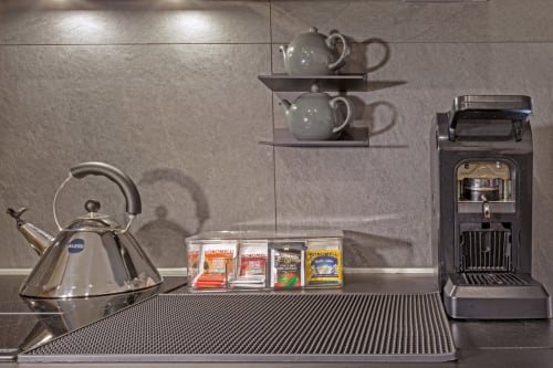Casa Mirko B&B Arezzo kitchen display with kettle, teapot, coffee machine and gourmet coffee selection