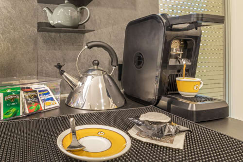 Casa Mirko coffee station in Arezzo with espresso machine, kettle, teapot, and tea selection on shelf
