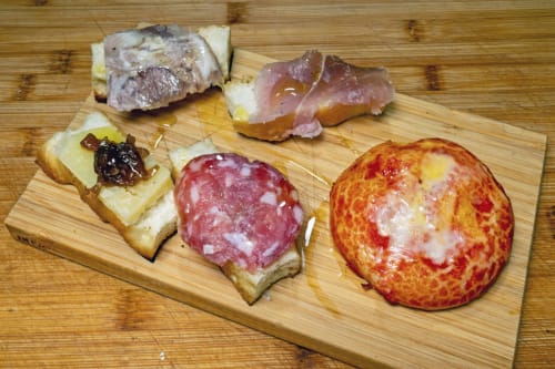 Charcuterie board at Casa Mirko B&B in Arezzo featuring cured meats, salami, and artisanal bread