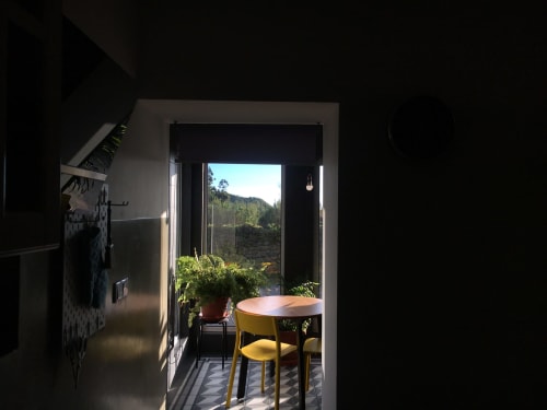 Design Nest balcony at Villa Várzea with mountain views, dining table, and yellow chair overlooking Portuguese countryside