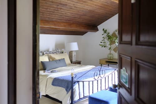 Country Suite bedroom at Villa Várzea with wrought iron bed, wooden ceiling, and mountain views in Várzea, Portugal