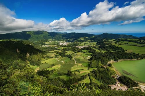 Aerial view of lush green valley with forests and farmland in Várzea, Portugal near Villa Várzea