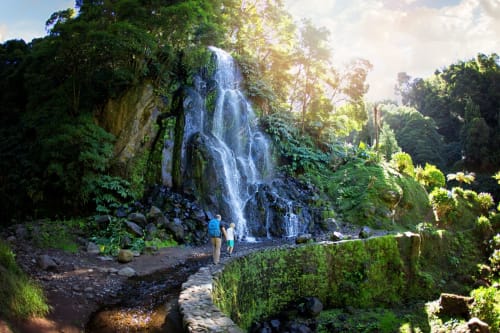 Waterfall surrounded by lush green forest at Villa Várzea, a bed and breakfast in Várzea, Portugal