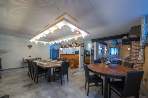 Salle à manger de la Villa Valtin avec tables modernes, chaises noires et cuisine à Le Valtin