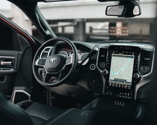 Modern truck interior with GPS navigation display, steering wheel with Dodge logo, digital dashboard in Limavady area