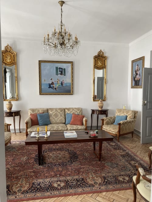 Elegant living room at Patio Da Villa guesthouse in Coruche with chandelier, ornate mirrors, and period furniture