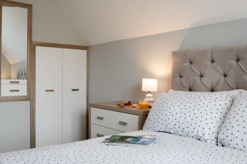 Cornish Holiday - 100 Hengar Manor.  Master bedroom showing hanging cupboard, chest of drawers and mirror.