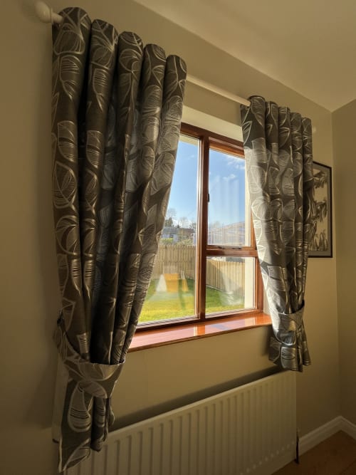 Room 6 window at Steeple View B&B Donegal with patterned curtains overlooking garden and countryside