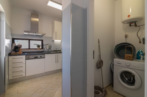 kitchen and washing machine | Sand & Sea Apartment – Modern Living with Ocean Views