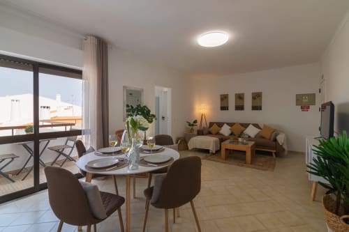 living and dining area with balcony and view | Sand & Sea Apartment – Modern Living with Ocean Views