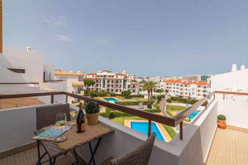 balcony with pool view | Sand & Sea Apartment – Modern Living with Ocean Views