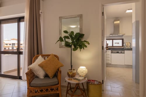 living area with kitchen view and balcony | Sand & Sea Apartment – Modern Living with Ocean Views