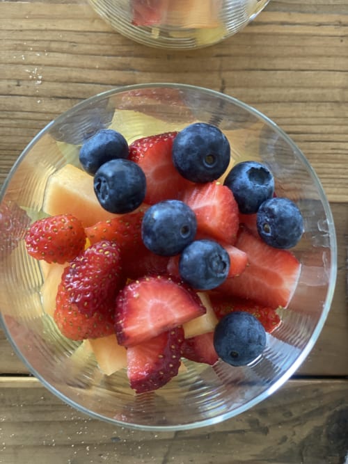 Fresh fruit platter with strawberries, blueberries, and melon at Verdolivo B&B in Sale Marasino