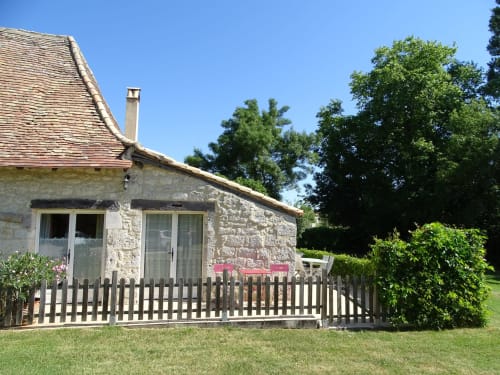 La Crèche cottage at La Barrat B&B in Monmarvès, France with white picket fence and gardens