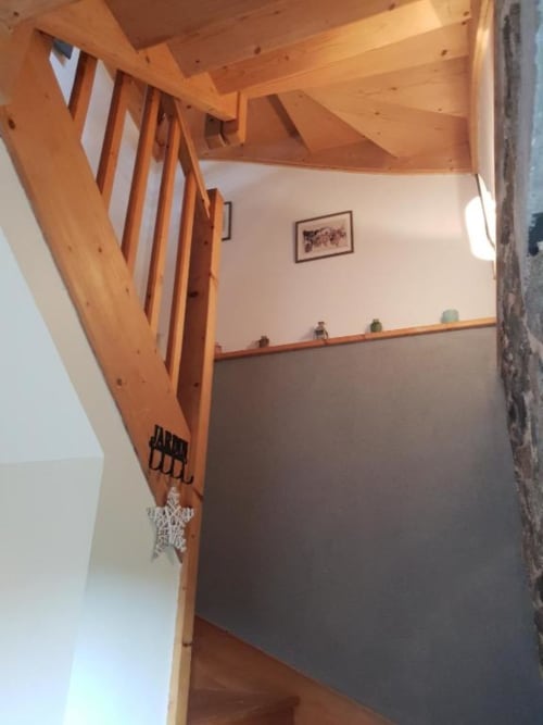 Escalier en bois avec bannière rayée blanche à la Gite de la Tannerie, La Conciergerie de Nathalie, Dinan