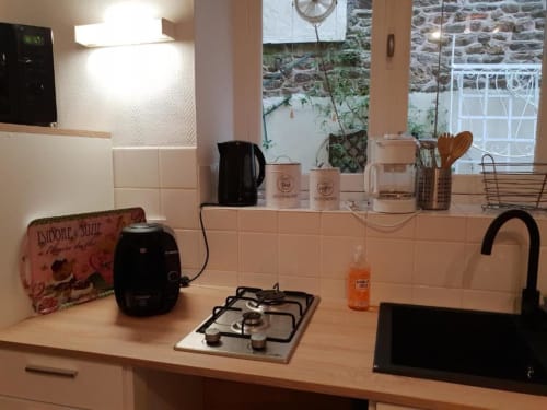 Cuisine moderne de l'appartement Ty Rose à La Conciergerie de Nathalie, Dinan avec cuisinière à gaz et évier