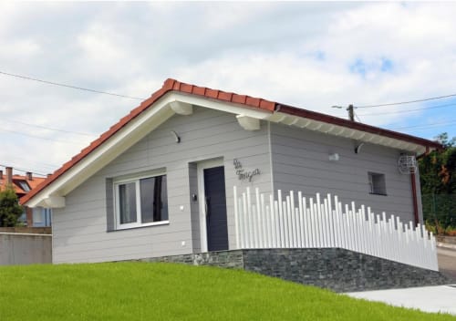 Modern guest house at Hotel Santorini Belgrade with white railings, terrace, and green lawn, contemporary B&B accommodation