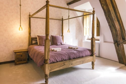 Élégant lit à baldaquin avec literie violette dans la chambre Les Clos de l'hôtel boutique Le Prieuré Du Preux à Sépeaux Saint Romain,