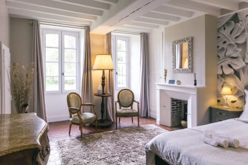 Elegant Valmur room at Le Prieuré Du Preux with garden view, fireplace, classic furniture and natural light