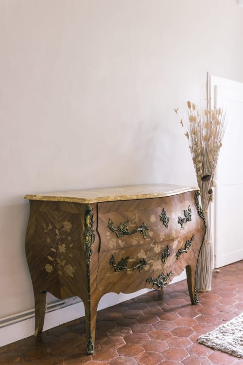 Ornate wooden dresser with marble top and decorative brass handles in Valmur room at Le Prieuré Du Preux, France