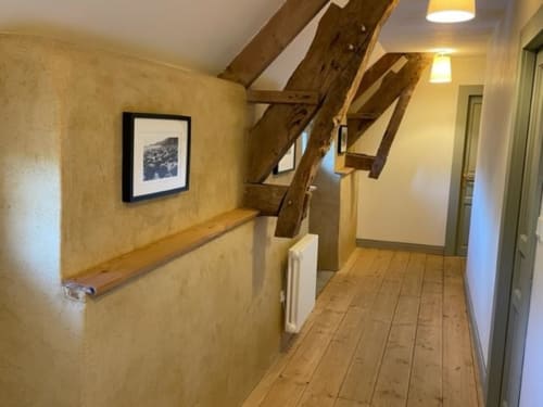 Bright hallway with wooden beams and staircase at Domaine du Tertre Ychot in Dol de Bretagne