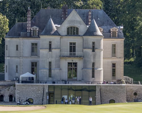 Elegant French château with turrets at Le Paradis de Lucile in La Roche Guyon, near Giverny, featuring modern glass entrance