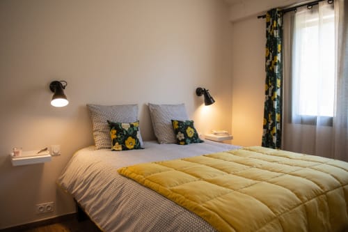 Comfortable bedroom with warm decor at Bastide Toujours Dimanche, Gordes, Provence, Luberon, France.