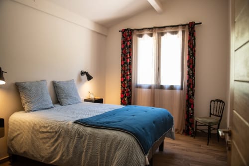 Elegant bedroom with authentic decor at Bastide Toujours Dimanche, Gordes, Luberon, Provence, France.