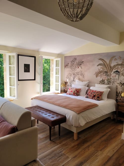 Luxurious bedroom at Pavillon Des Millésimes with botanical mural, king bed, and garden views