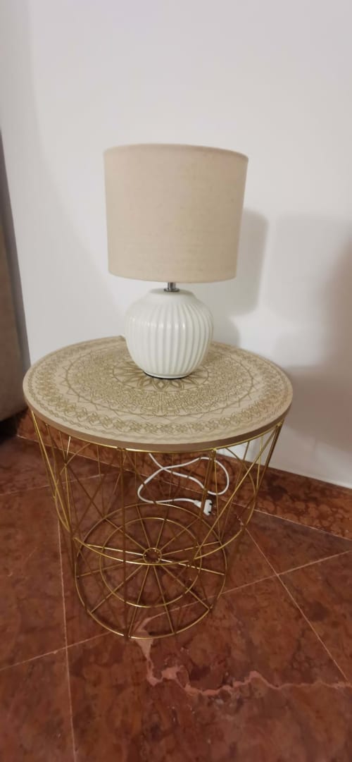 Cream ribbed ceramic table lamp on gold wire base with decorative round table in Casa Bellini apartment, Palermo