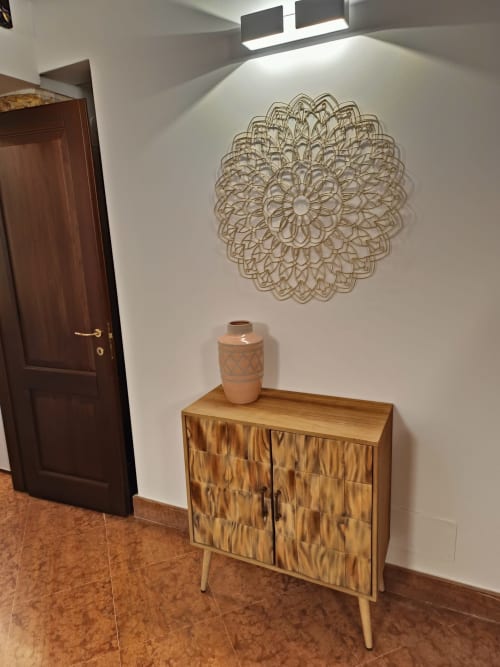 Entryway at Casa Bellini Palermo apartment with wooden cabinet, ceramic vase, and decorative mandala wall art under modern