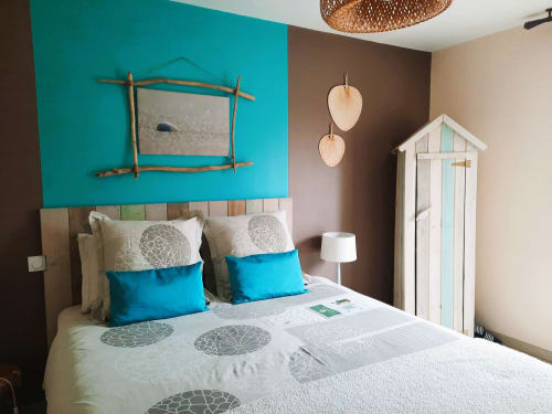 Belloréade Room Saona in Belloc with turquoise accent wall, wooden-framed mirror, white wardrobe, and garden view