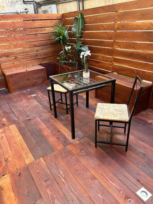 Terrace seating area at Maison Vaticana Guest House Rome with wooden table, chairs, and potted plant