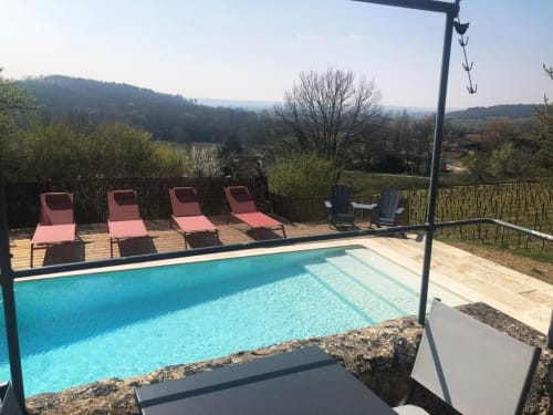 Piscine avec chaises longues au Château Haut Clarise, Belvès-de-Castillon, vue sur les vignobles