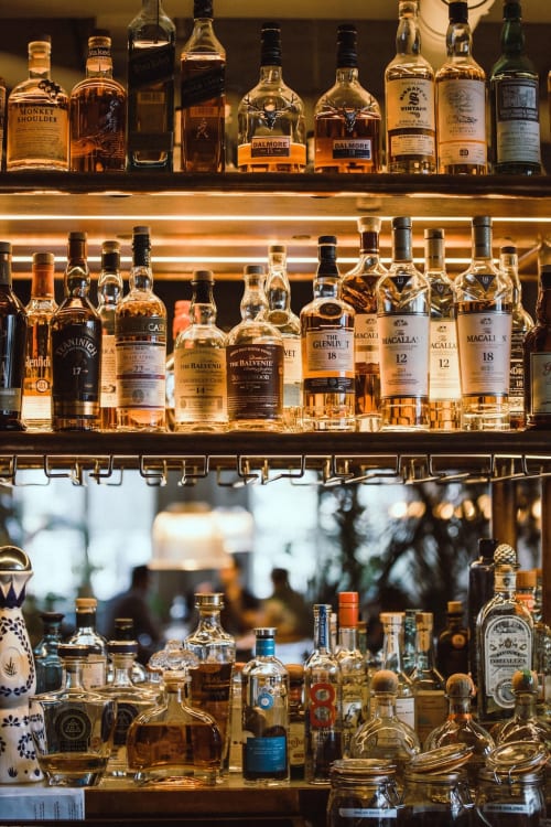 Premium whiskey collection on illuminated shelves at Seabrook Lodge bar in Clifden, Galway