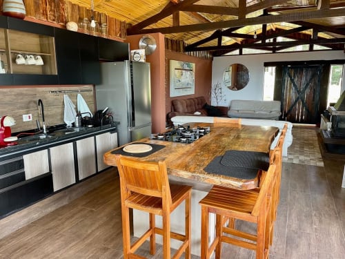 Cozinha e sala integrada da villa Paraíso nas Montanhas em Campos do Jordão, com mesa de jantar de madeira, design moderno