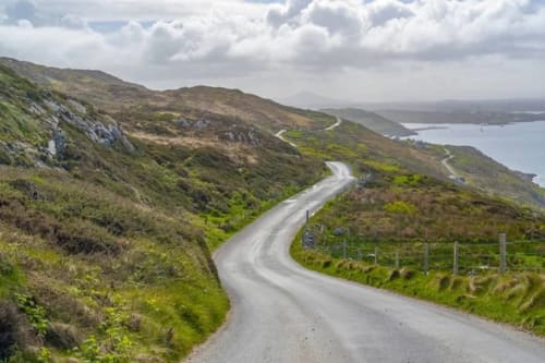 Winding coastal road through Irish countryside near Seabrook Lodge in Clifden, Galway